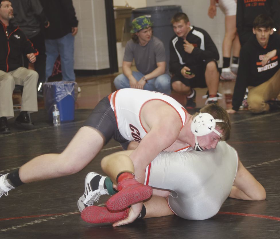 Shawn Proctor turning his opponent as three teammates look on.